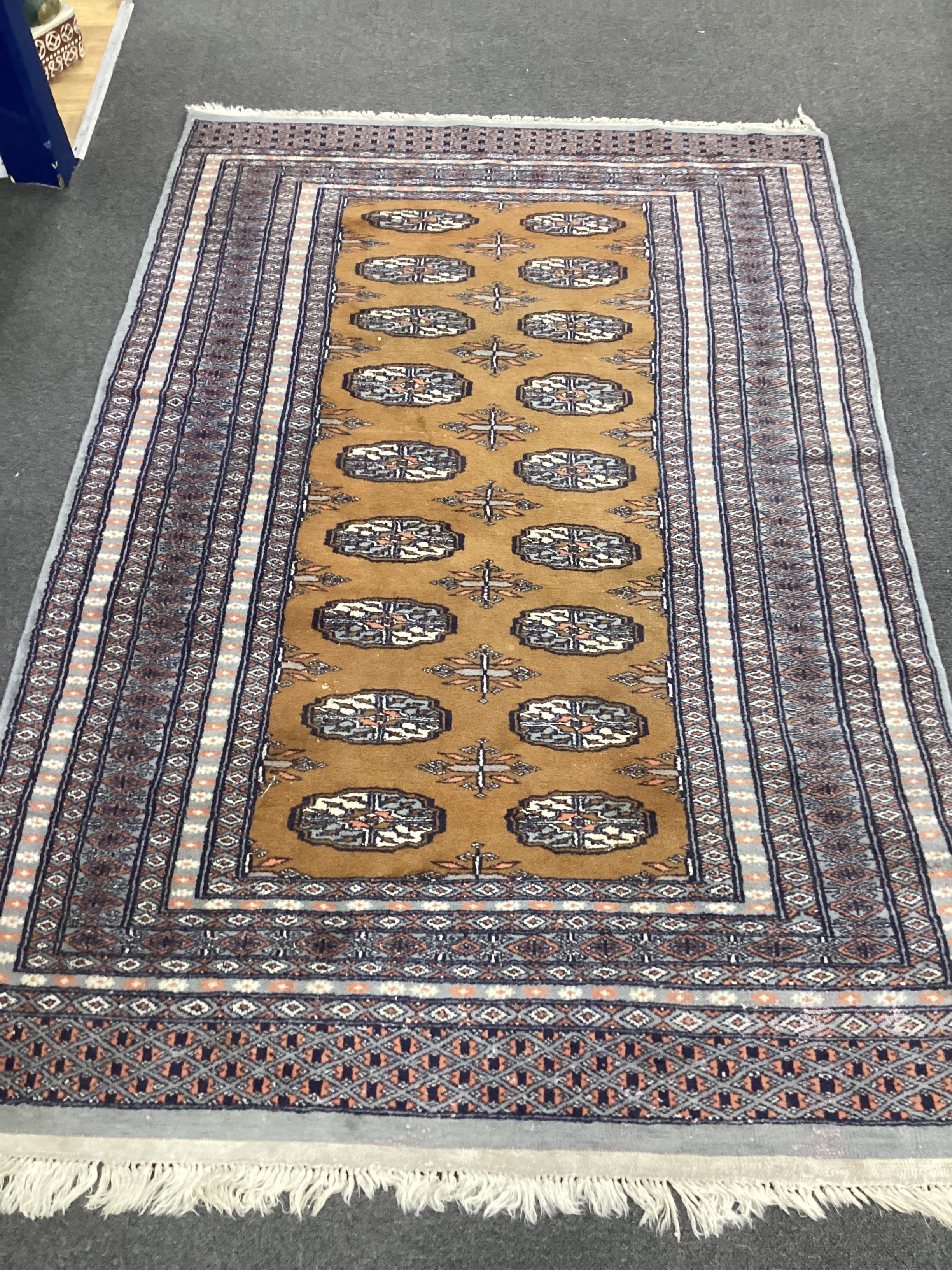 An Afghan red ground rug and a Bokhara gold ground rug, largest 180 x 121cm